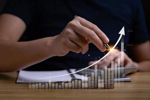 Concept of business success, finance and business strategy in investing successful. money growth and virtual graph with arrow pointing to success or profit photo