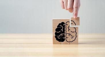 Brain shaped black wooden jigsaw puzzle with copy space. Concept The missing piece of the brain puzzle, mental health and memory problems. Solve problems intelligently photo