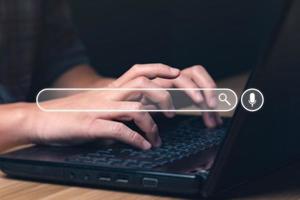 Businessman using laptop to search for information, surfing the Internet network concept information. Businessman hand using laptop to search. Searching Browsing Internet photo