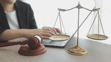 Business and lawyers discussing contract papers with brass scale on desk in office. Law, legal services, advice, justice and law concept video