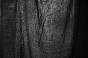 Black fabric on light. Fabric texture. Black background. photo