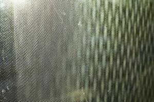 Glass surface in film. Texture of film on window. Blurry background of small waves. photo