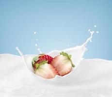 strawberries falling into a splash of milk isolated on blue background photo