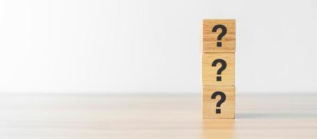 Questions Mark word with wood block on table background. FAQ, frequency asked questions, Answer, Q and A, Information, Communication, questionnaire and Brainstorming Concepts photo