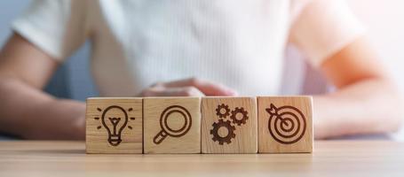 dartboard above Gear, magnifying and Lightbulb icon block. business planning process, goal, strategy, target, mission, action, research, teamwork and idea concept photo