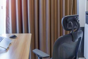 Ergonomic chair and Adjustable table with laptop computer in modern workplace. Good posture to avoid Office syndrome, Back Pain, shoulder ache, fibromyalgia and Neck pain photo