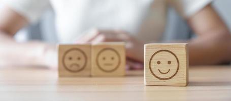 Happy smile face choosing from Emotion block for customer review, good experience, positive feedback, satisfaction, survey, evaluation, assessment, mood, world mental health day concept photo