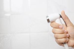 A man using a bidet in the bathroom photo