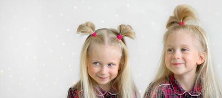 Two smiling girls in the plaid shirts photo