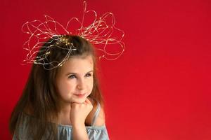 Pretty little girl with bow of  wire Christmas lights photo