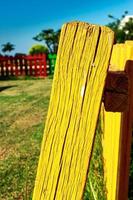 Yellow fence post of a playground. Vertical image. photo