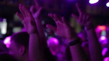 crowd at a rock concert in a bar dancing near the stage and raised his hands up video