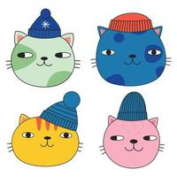 A set of cute cats' faces in winter hats. Doodle style. Vector illustration