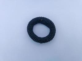 Black hair tie in white background photo