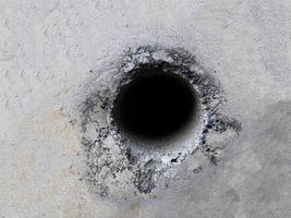 Background texture of cement wall with hole in the middle photo