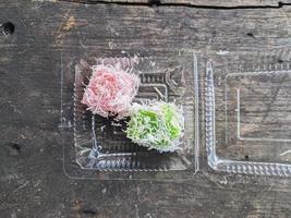 putu cake. typical street food in Indonesia with toppings from grated coconut photo