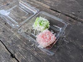 putu cake. typical street food in Indonesia with toppings from grated coconut photo