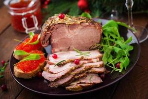 Christmas baked ham and red caviar, served on the old wooden table. photo