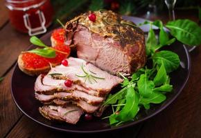 Christmas baked ham and red caviar, served on the old wooden table. photo