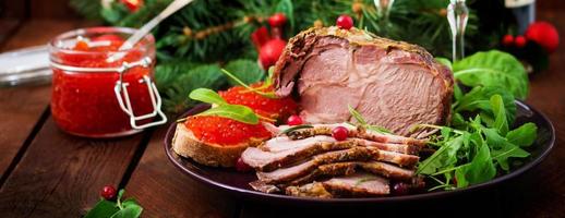 Christmas baked ham and red caviar, served on the old wooden table. Banner