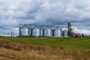 agro silos granary elevator with seeds cleaning line on agro-processing manufacturing plant for processing drying cleaning and storage of agricultural products photo