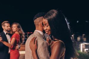 Beautiful young people dancing and smiling while spending time on party photo