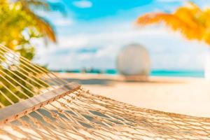 Idyllic beach with coconut trees and hammock, tranquil relaxing summer vibes. Recreational closeup, peaceful beach landscape. . Perfect beach scene vacation and summer holiday concept photo