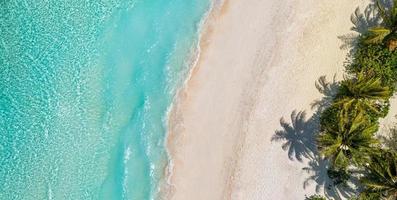Relaxing aerial beach panorama summer vacation holiday panoramic banner. Waves surf with amazing blue ocean lagoon, sea shore, coastline. Perfect aerial drone top view. Beautiful bright beach, seaside photo