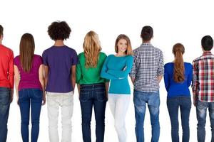 She is a real leader. Young multi-ethnic people standing in a row and back to camera while beautiful young woman keeping arms crossed and smiling at camera photo