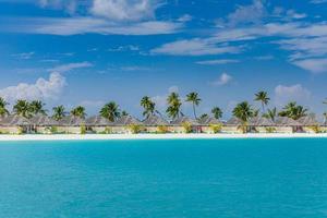 Outdoor tourism landscape. Luxurious beach resort with swimming pool and beach chairs or loungers under umbrellas with palm trees, sunny sky. Summer travel and vacation background concept photo