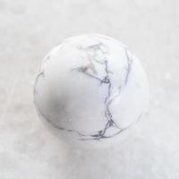 ball from Howlite gemstone on white marble photo