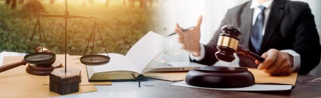 Business and lawyers discussing contract papers with brass scale on desk in office. Law, legal services, advice, justice and law concept picture with film grain effect photo