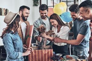 Group of young modern people taking selfie using smart phone while they having a dinner party photo