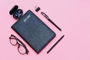 Items for business person, black glasses with notebook and pen, trendy wireless photo