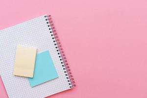 An open spiral notepad with stickers lying on top. Stationery photo