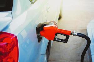 Gas station nozzles. Cars that are refueling in the gas station. The concept of fuel prices has changed. photo