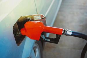 Gas station nozzles. Cars that are refueling in the gas station. The concept of fuel prices has changed. photo