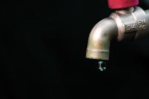 A faucet where the water does not flow. The concept of water scarcity and the water crisis photo