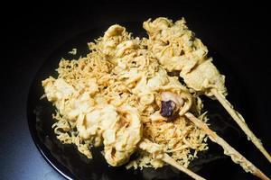 Battered squid in plate and black background. Food concept that cooks with fries makes you fat photo