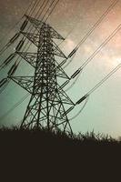 Silhouettes of high voltage poles and power lines It has a complex steel structure, it is strong and durable. photo