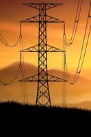 Silhouettes of high voltage poles and power lines It has a complex steel structure, it is strong and durable. photo