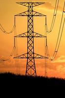 Silhouettes of high voltage poles and power lines It has a complex steel structure, it is strong and durable. photo