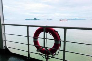 Lifebuoy attached to the side of the boat Ready to use in an emergency. Maritime safety concept photo
