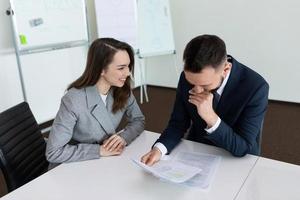 office workers at the table laughing photo