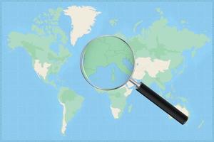 Map of the world with a magnifying glass on a map of Monaco. vector