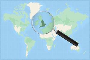 Map of the world with a magnifying glass on a map of England. vector