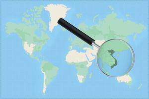 Map of the world with a magnifying glass on a map of Vietnam. vector