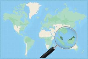 Map of the world with a magnifying glass on a map of Malaysia. vector