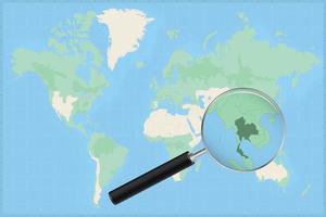 Map of the world with a magnifying glass on a map of Thailand. vector