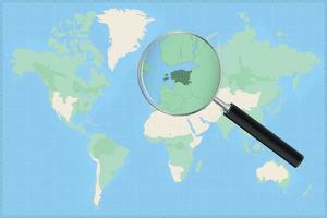 Map of the world with a magnifying glass on a map of Estonia. vector